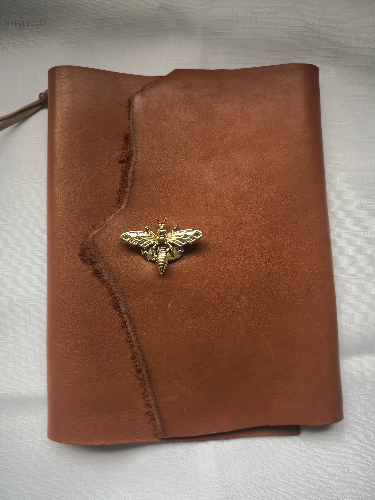 Handcrafted leather journal with wasp clasp, perfect for travel writing and gifting