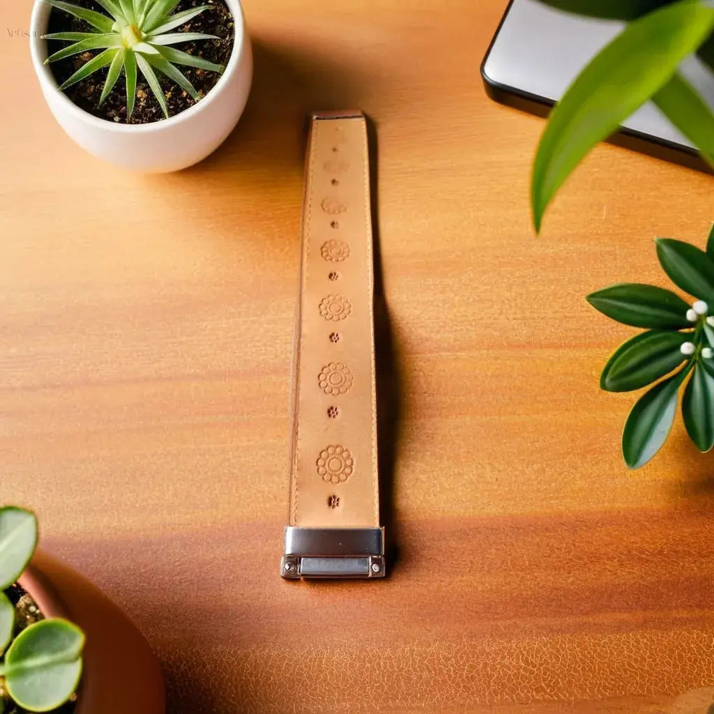 Hand-tooled leather bracelet in natural tan with flower-stamped design, perfect for gifting or daily wear